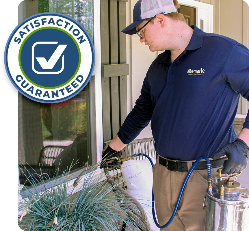 Technician spraying exterior of house